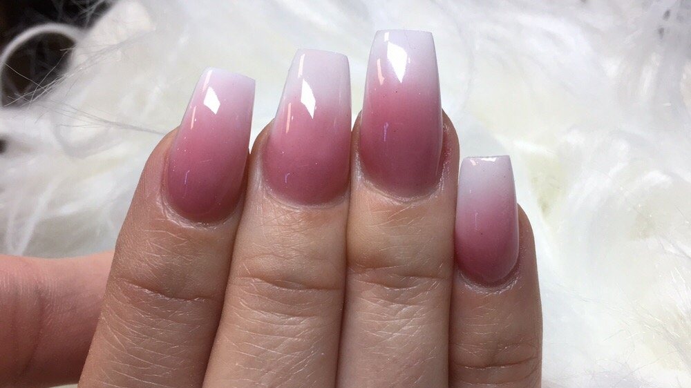 Close-up of coffin nails with a pink-to-white ombre