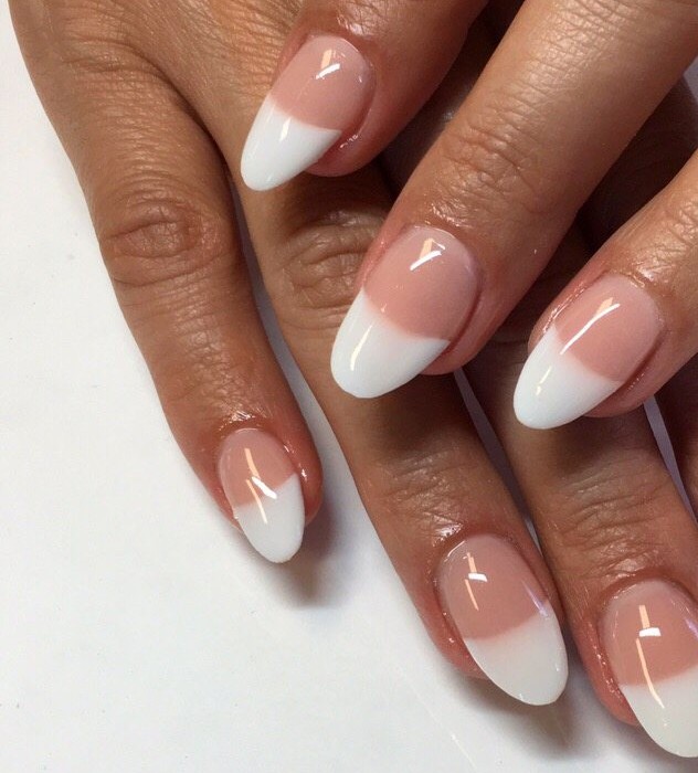 Almond nails with a sheer pink base and white French tips